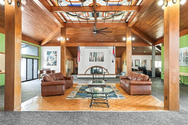 living area with beamed ceiling, wooden ceiling, high vaulted ceiling, and a ceiling fan