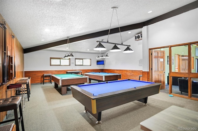 recreation room with carpet floors, wooden walls, and wainscoting