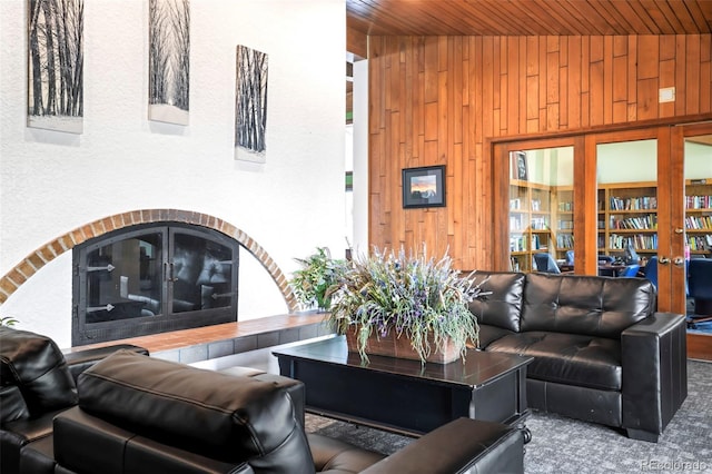 living room with wooden walls and wooden ceiling