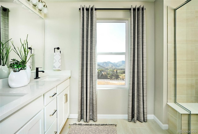 bathroom featuring vanity and tiled shower