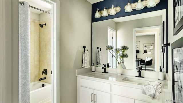 bathroom with double vanity, shower / bath combo, and a sink