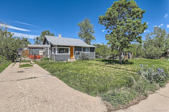 1271 Uinta St, Denver, CO 80220 - view of front of property with a chimney, a front lawn, roof with shingles, and entry steps