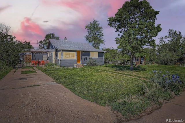 1271 Uinta St, Denver, CO 80220 - view of front of home with entry steps, a yard, a shingled roof, and a chimney