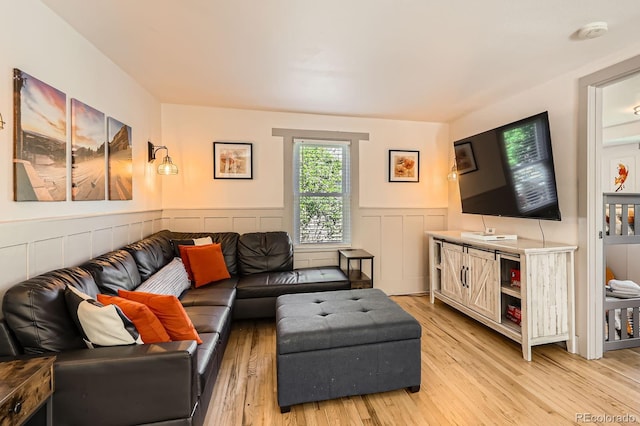 1271 Uinta St, Denver, CO 80220 - living room featuring a wainscoted wall and light wood-style flooring