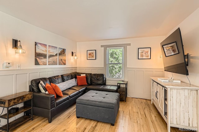 1271 Uinta St, Denver, CO 80220 - living area with wainscoting, a decorative wall, and light wood-style floors