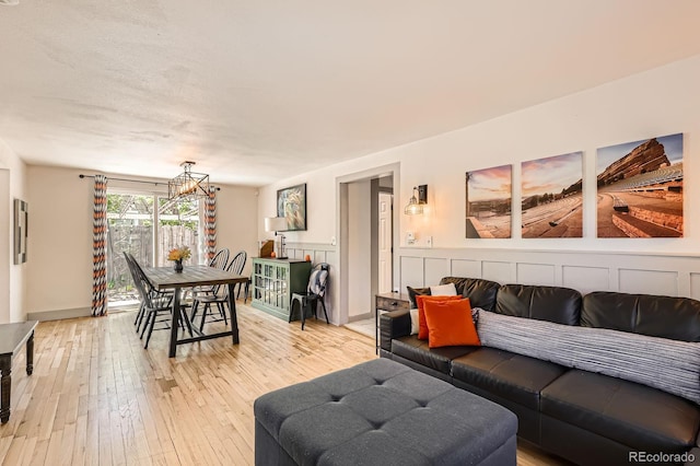 1271 Uinta St, Denver, CO 80220 - living area featuring a chandelier and light wood-type flooring
