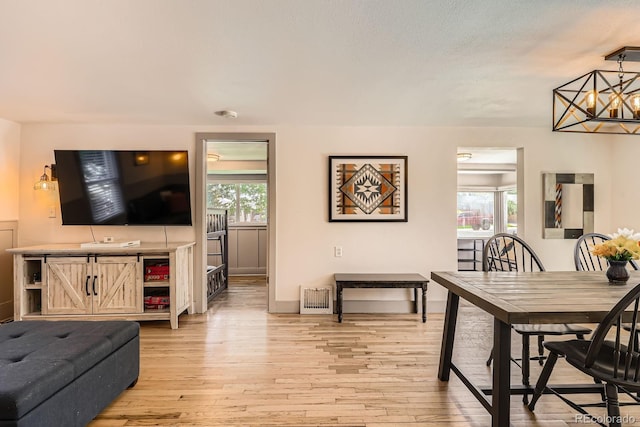 1271 Uinta St, Denver, CO 80220 - dining area with light wood-type flooring and a chandelier