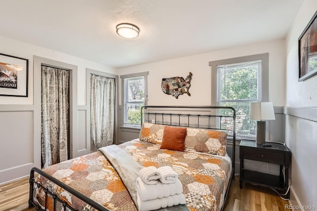 1271 Uinta St, Denver, CO 80220 - bedroom featuring wood finished floors and multiple windows
