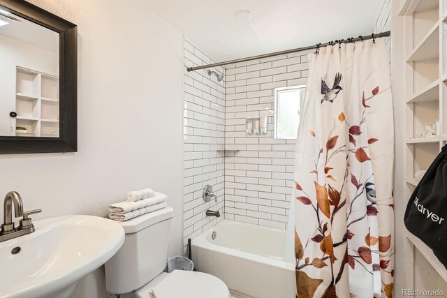 1271 Uinta St, Denver, CO 80220 - full bathroom featuring a sink, shower / bath combo with shower curtain, and toilet