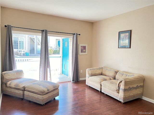 living room featuring dark wood-style floors and baseboards