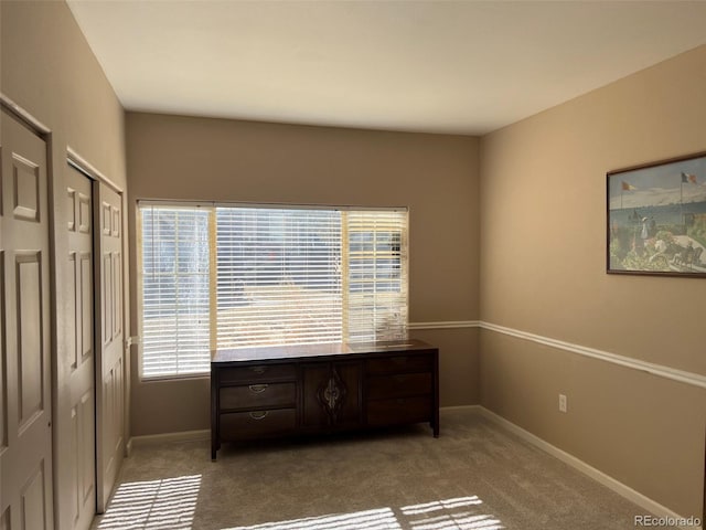 bedroom featuring carpet and baseboards