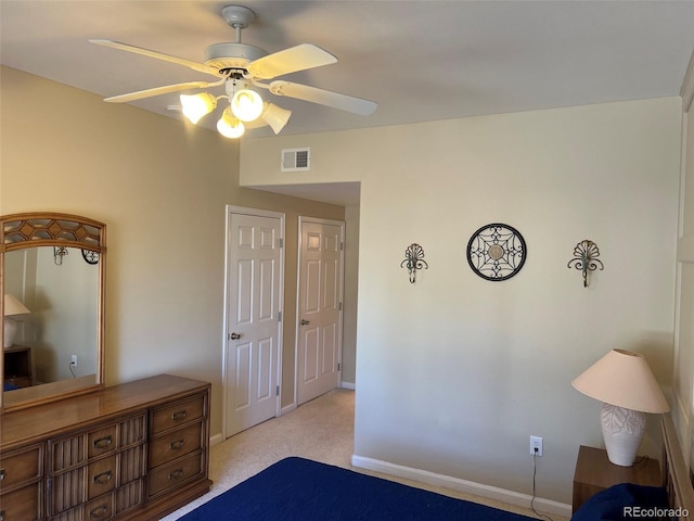 bedroom featuring light colored carpet, visible vents, ceiling fan, and baseboards