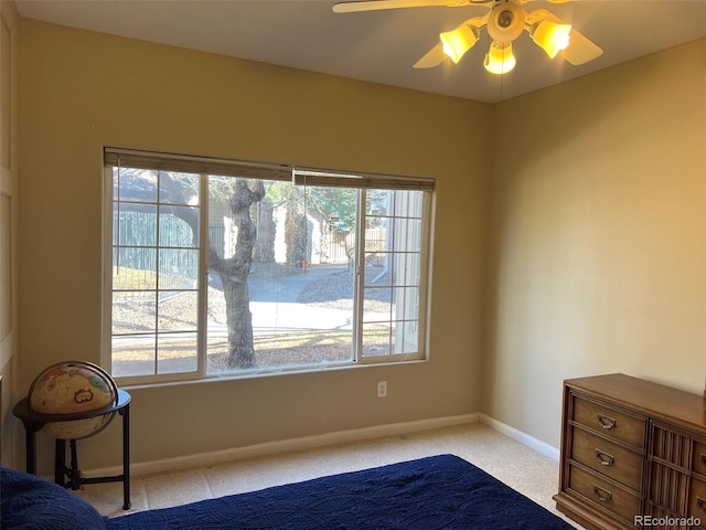 unfurnished bedroom with ceiling fan, carpet floors, and baseboards