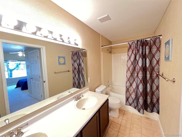 bathroom with double vanity, visible vents, toilet, and a sink