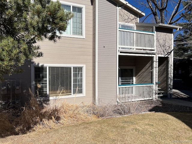 view of home's exterior with covered porch and a balcony