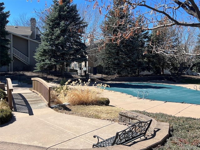 view of pool featuring a covered pool and a patio