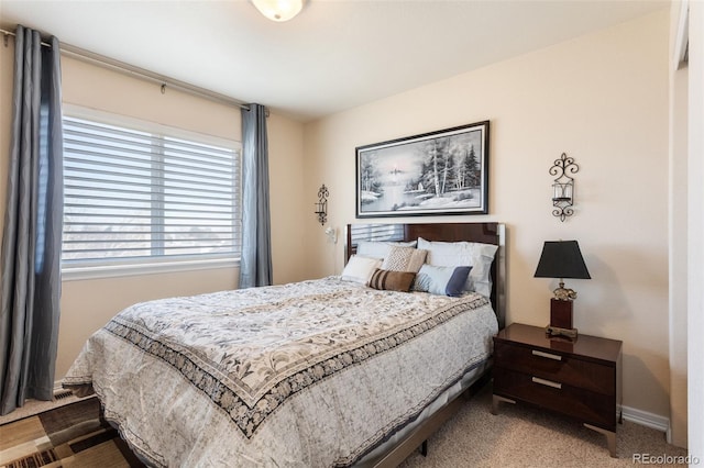 bedroom with carpet flooring and baseboards