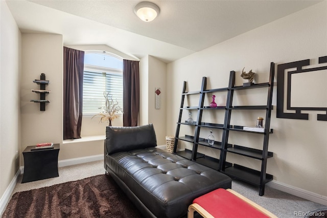 sitting room with lofted ceiling, carpet flooring, and baseboards