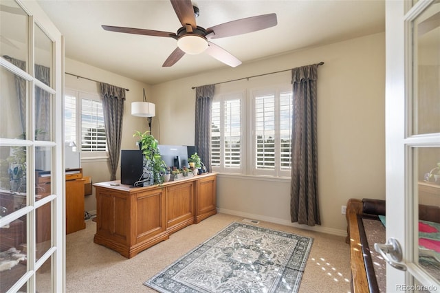 office space featuring french doors, light colored carpet, ceiling fan, and baseboards