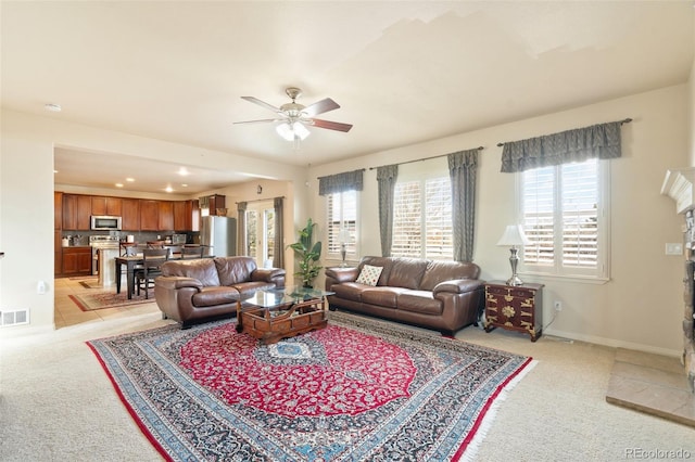 living room featuring a fireplace, recessed lighting, light carpet, ceiling fan, and baseboards