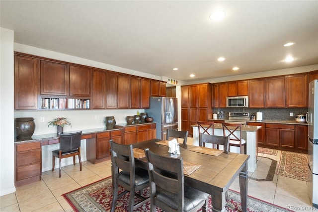 dining room featuring light tile patterned floors, built in study area, and recessed lighting