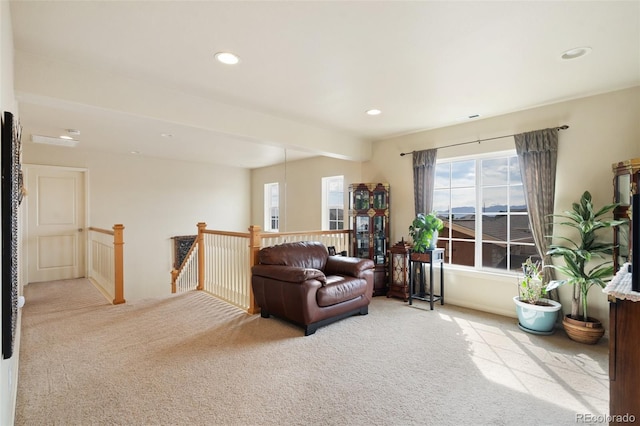 living area featuring visible vents, carpet flooring, an upstairs landing, and recessed lighting