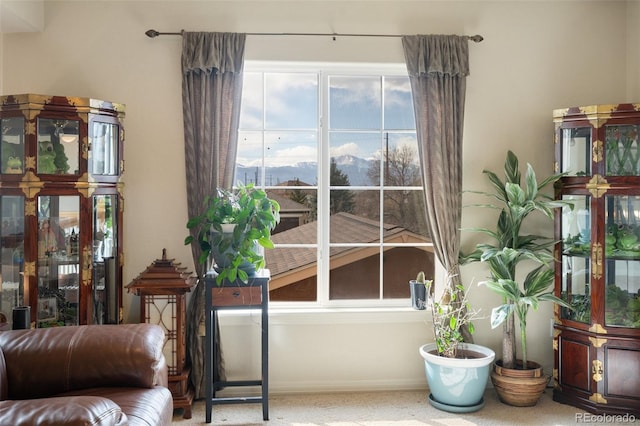 living area featuring baseboards and a mountain view