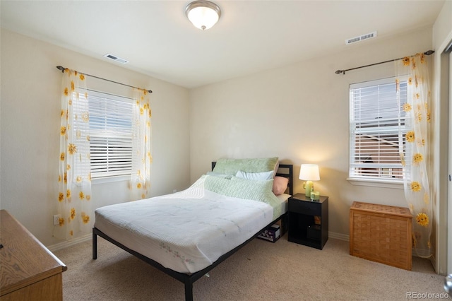 bedroom with carpet, visible vents, and baseboards