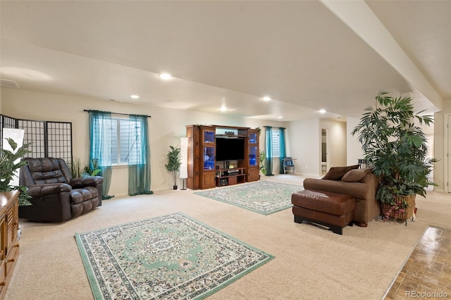 carpeted living area with baseboards, visible vents, and recessed lighting