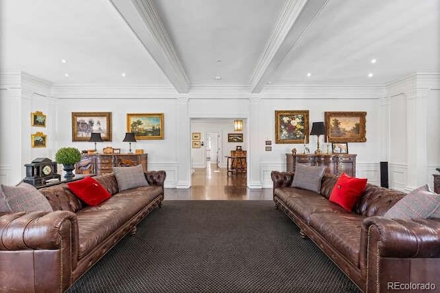 living room featuring dark hardwood / wood-style flooring, ornamental molding, beamed ceiling, and ornate columns