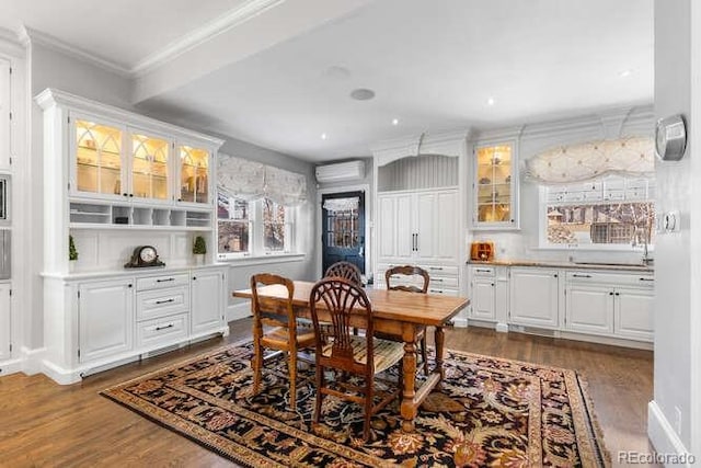 dining room with dark wood-type flooring, ornamental molding, and a wall mounted AC