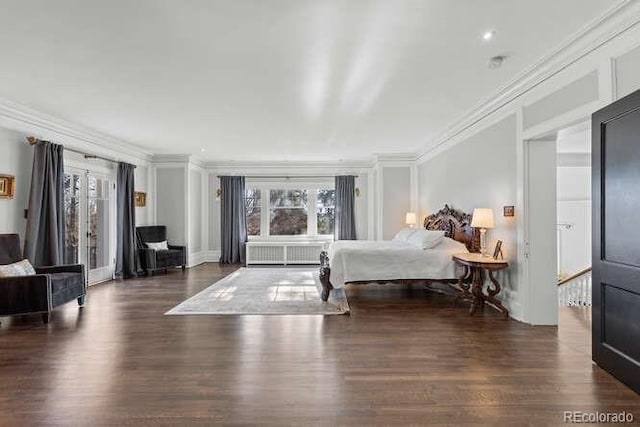 bedroom featuring crown molding and dark hardwood / wood-style floors