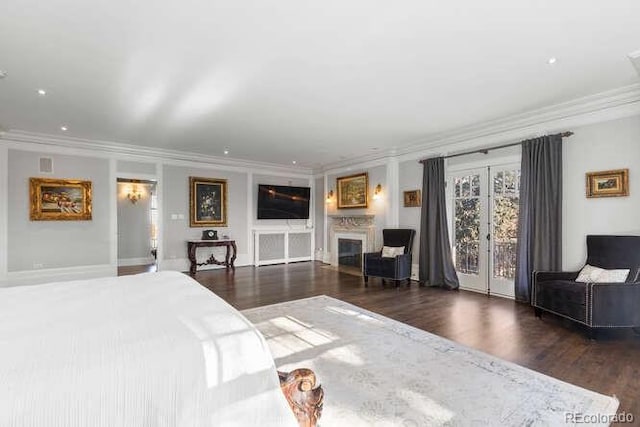 bedroom featuring ornamental molding, dark wood-type flooring, access to outside, and french doors