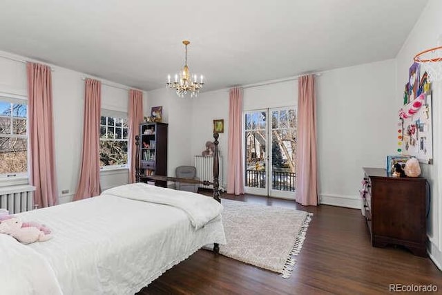 bedroom with multiple windows, dark wood-type flooring, access to outside, and a chandelier