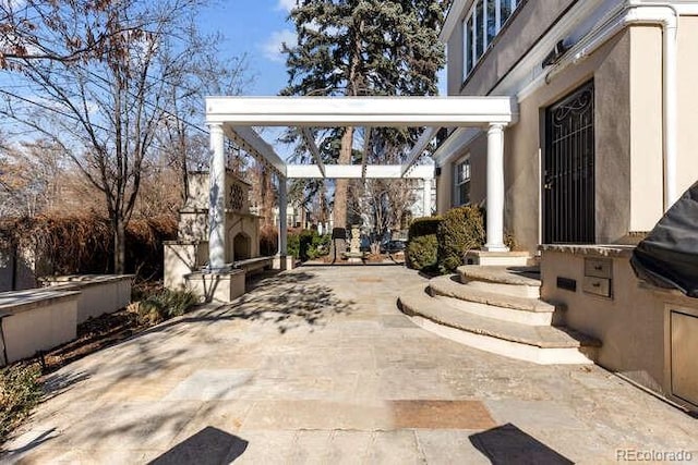 view of patio featuring a fireplace