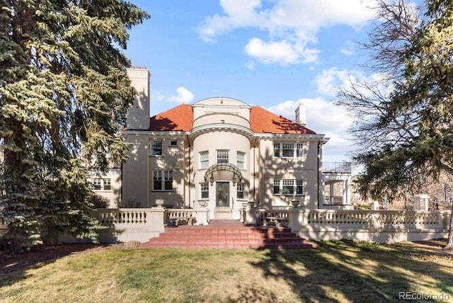 rear view of property featuring a yard