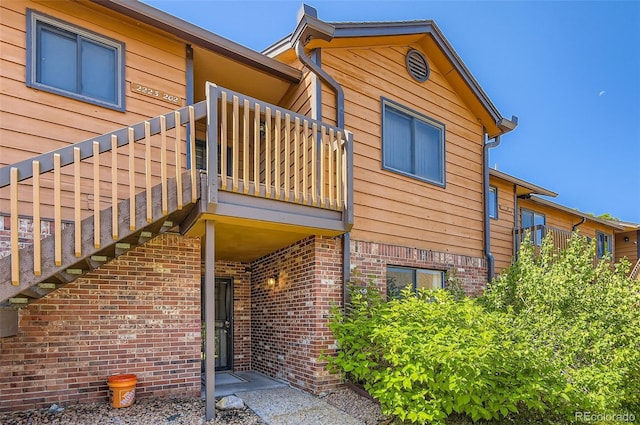 2223 S Buckley Rd Unit 102, Aurora, CO 80013 - view of home's exterior featuring a balcony and brick siding