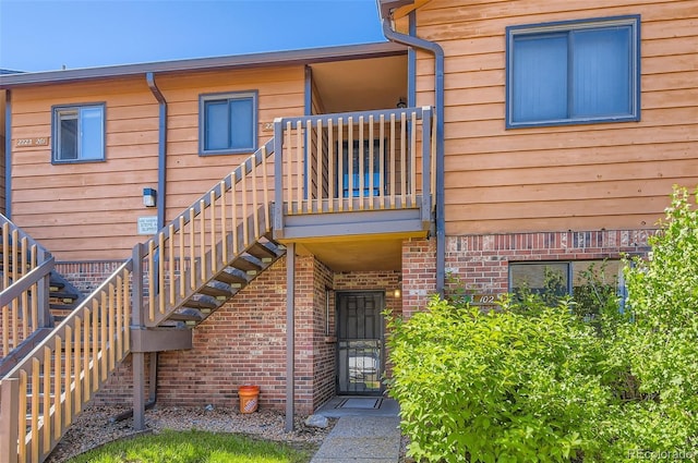 2223 S Buckley Rd Unit 102, Aurora, CO 80013 - view of exterior entry featuring brick siding and a balcony