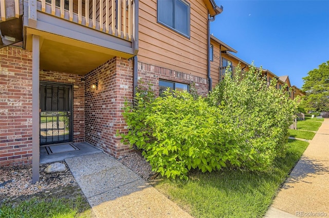 2223 S Buckley Rd Unit 102, Aurora, CO 80013 - view of exterior entry with a balcony and brick siding