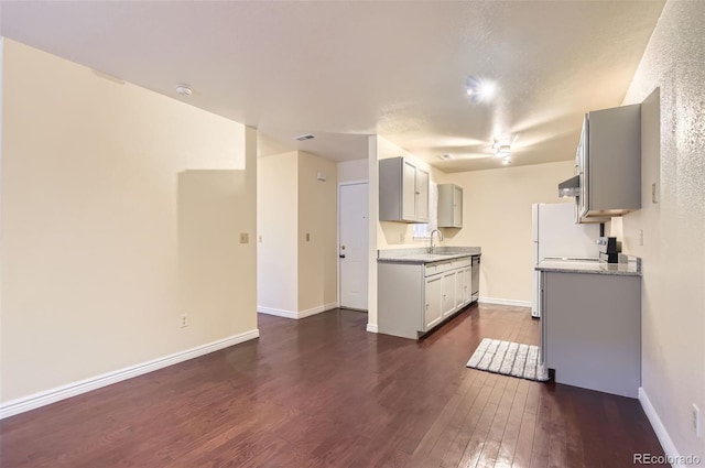 2223 S Buckley Rd Unit 102, Aurora, CO 80013 - kitchen with dark wood-style flooring, stainless steel dishwasher, light countertops, and gray cabinetry