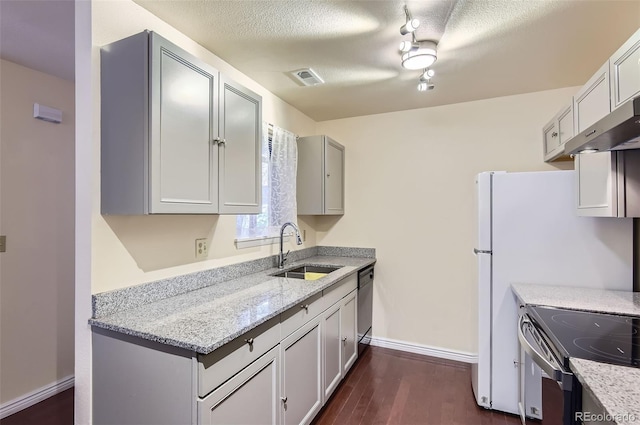 2223 S Buckley Rd Unit 102, Aurora, CO 80013 - kitchen with dark wood-style flooring, appliances with stainless steel finishes, light stone countertops, under cabinet range hood, and a textured ceiling