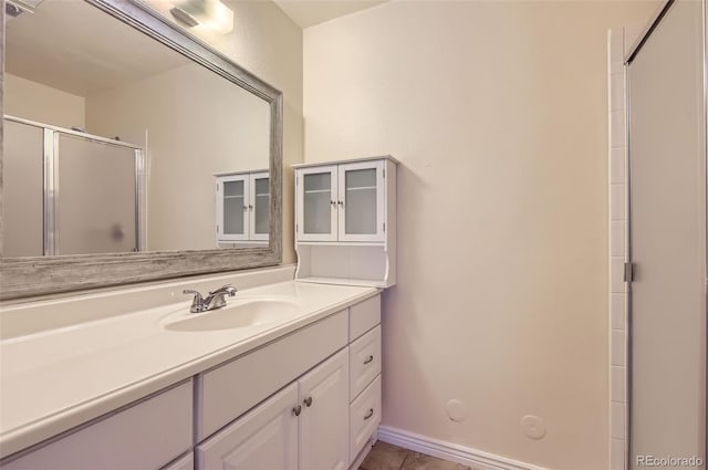 2223 S Buckley Rd Unit 102, Aurora, CO 80013 - bathroom with a shower with door, vanity, and tile patterned floors