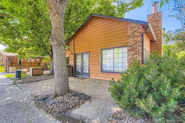 2223 S Buckley Rd Unit 102, Aurora, CO 80013 - view of front of house with a chimney, brick siding, and a patio