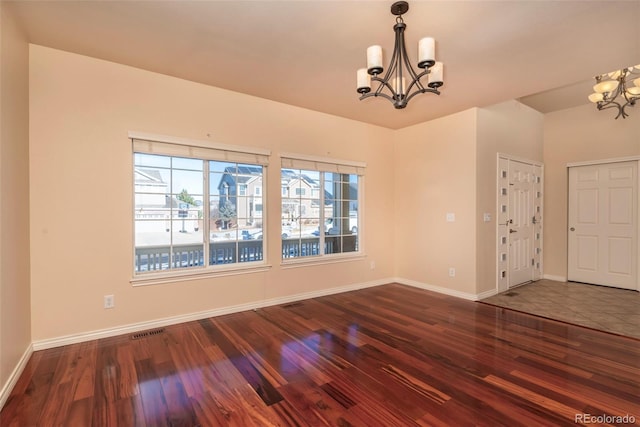 interior space featuring dark wood-type flooring and an inviting chandelier