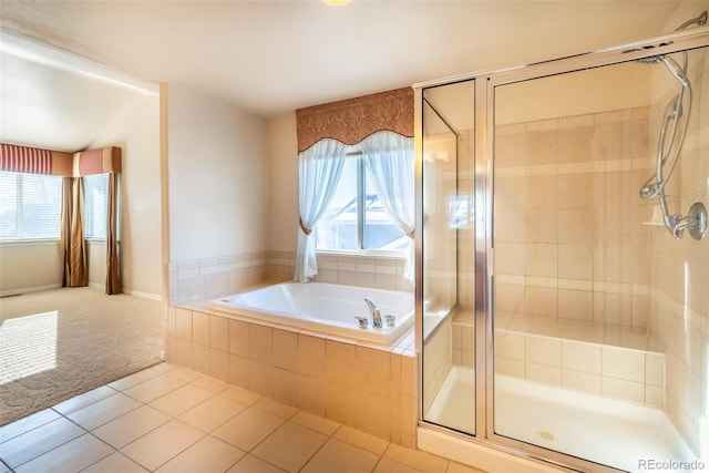 bathroom with tile patterned flooring, plenty of natural light, and a shower with door