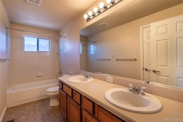 full bathroom with tile patterned flooring, vanity, toilet, and tiled shower / bath combo