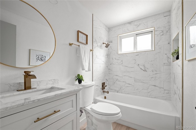 full bathroom featuring toilet, tiled shower / bath combo, and vanity