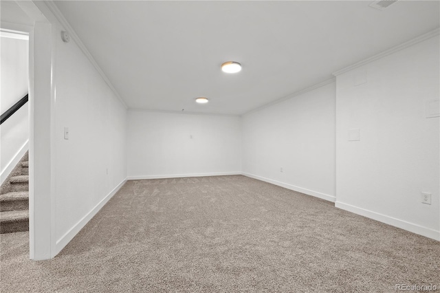 carpeted empty room featuring crown molding