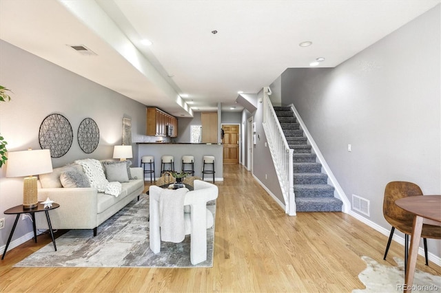 3030 Wyandot St Unit 4, Denver, CO 80211 - living room featuring stairs, light wood finished floors, and baseboards