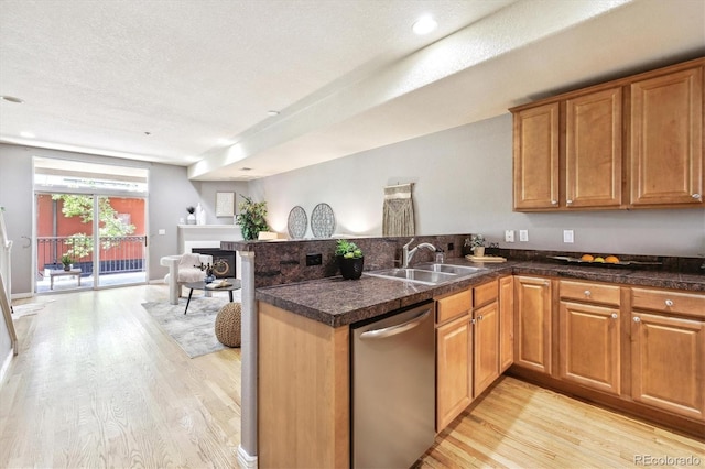 3030 Wyandot St Unit 4, Denver, CO 80211 - kitchen with stainless steel dishwasher, a sink, a peninsula, light wood-style floors, and tile counters